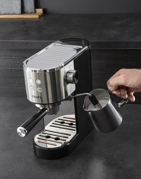 Semi Automatic Espresso Coffee Maker With Built In Steam Wand And High Pressure Pump For Rich Creamy Shots with frothing pitcher in use.