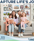 Family sitting on a sofa in a living room with a gallery of photos in sleek black 5x7 picture frames from the Bliss Collection on the wall.