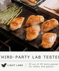 Made In Professional Carbon Steel Griddle With Cast Iron Grill Press, Giant Hibachi Style Plancha Combo For Indoor Outdoor Cooking, Induction Compatible Heavy Duty Flat Top Pan Up To 1200 Degrees Fahrenheit grilling chicken and asparagus on a flat top grill.