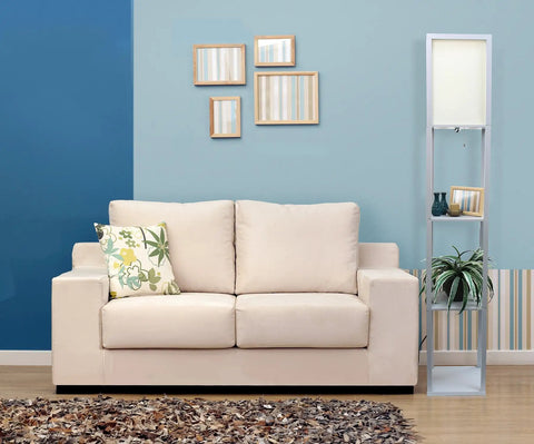 Sleek Gray Etagere Floor Lamp With Linen Shade And Built-In Shelves beside a beige sofa in a modern living room.