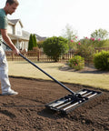 Person using Heavy Duty Lawn Leveling Rake With Four Spiked Wheels And Smooth Roller For Multi Surface Grading Ideal For Golf Course Bunkers