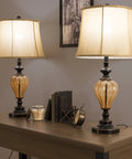 Set Of 2 LED Table Lamps With Amber Glass And Dark Bronze Metal Finish on a wooden table in a modern room setting
