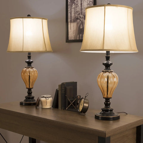 Set Of 2 LED Table Lamps With Amber Glass And Dark Bronze Metal Finish on a wooden table in a modern room setting