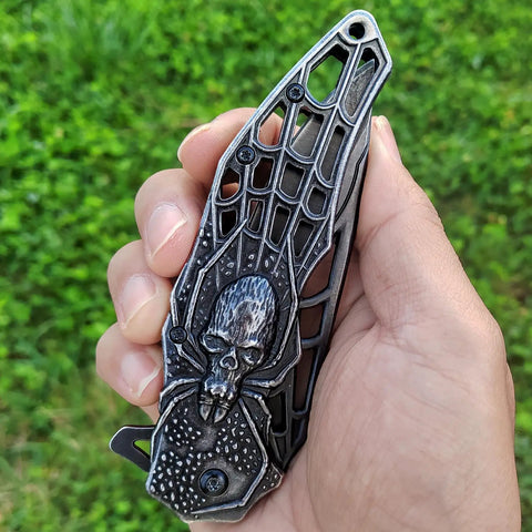 Pocket Folding Knife With 3D Embossed Skull Pattern, intricate handle detail, outdoor background, 3.6 Inch Razor Sharp 440 Blade
