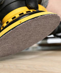 Open Mesh Dust Free Sanding Discs 220 Grit 5 Inch Hook And Loop attached to an orbital sander, showcasing dust-free sanding on wood.