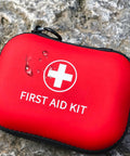 Red travel-size mini first aid kit case with a white cross and zip closure