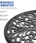 Close-up of cast aluminum outdoor side table with umbrella hole, showcasing ornate design and retro black finish