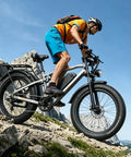 Rider on Powerful 2500W Peak Electric Fat Tire Bike for Adults with 52V 20Ah battery, dual suspension, climbing off-road terrain