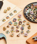 Three Eighths Inch T Nuts Sixteen Thread Four Pronged Tee Nuts Zinc Plated Steel Corrosion Resistant Seven Sixteenths Inch Barrel Length Iridescent Zinc Finish Beefy 300 Pack For Rock Climbing Holds Wood And Cabinetry - assorted T-nuts on table with drill and hammer