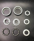 Components of 2 Inch Cup Bottom Bracket Conversion Kit For Bikes Converts One Piece Crank To Three Piece on black background