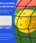 Close-up of yellow pickleball against triple-layered polyester net from Six Foot Mini Pickleball Net Set With Quick Setup For Indoor And Outdoor Play Portable Practice Net For Backyard And Driveway Lightweight Dink Training Aid To Sharpen Serves And Precision Shots.