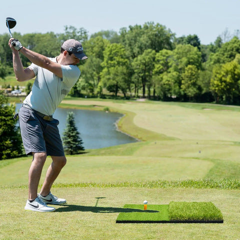 Golfer using Big 23 By 16 Inch Foldable Golf Hitting Mat With 2 In 1 Turf For Rough And Fairway Practice on outdoor course