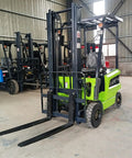 Heavy Duty Electric Forklift Truck Featuring Punchy Motors And Rock Solid Tires in warehouse with visible black forks.