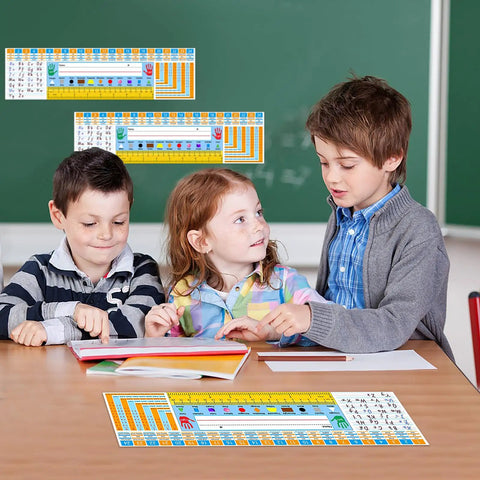 Kids at desks with Self Adhesive Classroom Nameplates With Alphabet Chart, Numbers And Addition Chart, Shapes And Colors.
