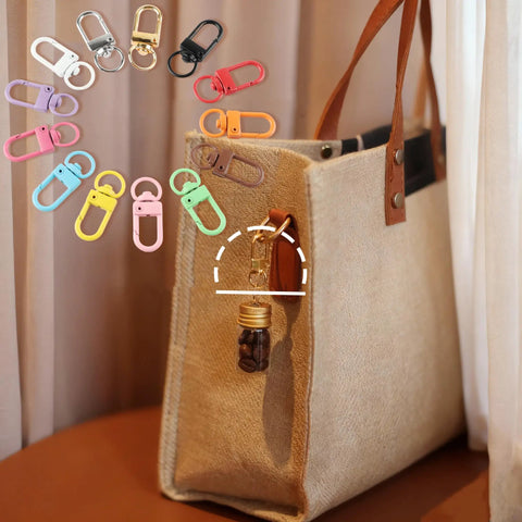 Seventy Eight Piece Small Swivel Snap Lobster Claw Clasps In Assorted Bold Shades attached to a stylish bag for versatile crafting use.