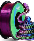 Tri Color Coextruded PLA Filament 1.75mm For 3D Printing With Silk Rainbow Pink Blue Green Finish Dope Multicolor Look Plus Minus 0.02mm Tolerance 1kg Spool For Vivid Prints And Tiny Details next to rainbow-colored 3D snake model.