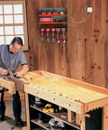 Heavy Duty Wall Mount Drill Organizer And Cordless Tool Storage Rack with tools and chargers in a workshop setting on a wooden wall