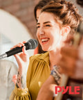 Woman singing with Stage And Studio Dynamic Cardioid Microphone With Built-In Pop Filter, Rugged Zinc Alloy Body, High Gain, 15-Foot XLR Cable.