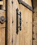 Heavy Duty Cast Iron Door Pull Handles Set Of 2 In Rustic Black With Colonial Victorian Style installed on wooden barn door
