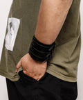 Fresh Hip Hop Drip Wide PU Leather Cuffs For Men adjustable black faux leather band worn on wrist with casual outfit.