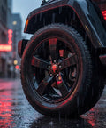 Four Pack Red Metal Skull Wheel Center Hub Cap Stickers Self Adhesive Waterproof Rim Covers on black wheel in rain.