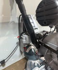 Installed Custom 3D Printed Dust Collection Attachment For 12 Inch Glide Miter Saw GCM12SD Dust Port Adapter, black, shop vacuum hose attached.