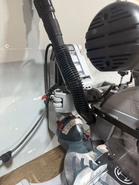 Installed Custom 3D Printed Dust Collection Attachment For 12 Inch Glide Miter Saw GCM12SD Dust Port Adapter, black, shop vacuum hose attached.