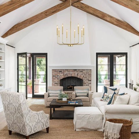 Gold 8 Light Modern Farmhouse Chandelier For Dining Room Kitchen Island Foyer And Living Room Rustic Industrial Candle Pendant Light Fixture With Cupless Candelabra Sockets hanging in living room with vaulted ceiling and beams.