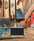 Heavy Duty Aluminum Tool Case With Dead Secure Latch And Comfy Grip Handle For Organizing Multi Purpose Large Capacity Work Gear Tablets Screws And Electronic Devices Portable Storage Box in a workshop with tools.