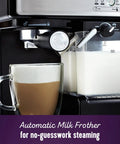 Close-up of Three In One Espresso And Cappuccino Machine with automatic milk frother in use next to a glass cup with cappuccino