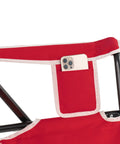 Comfort Pro Rocker Camping Chair With Drink Holder, highlighting red fabric armrest with phone pocket.
