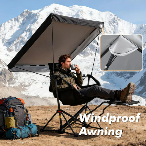 Person sitting in Portable Folding Hammock Camping Chair With Canopy And Footrest, scenic mountain backdrop, windproof feature shown