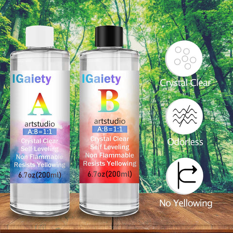 Backdrop of forest with two epoxy bottles labeled A and B featuring clear, odorless, non-yellowing liquids, part of Backward Alphabet Molds Starter Kit With 206 Silicone Resin Molds For Epoxy Jewelry Making And Keychains Beginner Friendly Craft Set Includes Accessories For Easy Casting And DIY Projects.