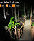 Person using Sofirn SP10 Pro BLF Anduril2 Version Mini EDC Flashlight With LH351D LED 90 CRI illuminating a garden path at night