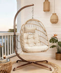 Outdoor Egg Chair With Stand For Patio Backyard Hanging Swing Chair With Foldable Rattan UV Resistant Padded Cushion 350 Lb Capacity Beige Cozy And Chill on porch
