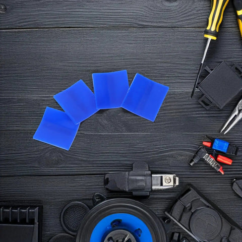 4 Piece Auto Dent Repair Kit With Plastic Puller Tabs And Heavy Duty Sheet Metal Expander, blue tabs, tools on table.