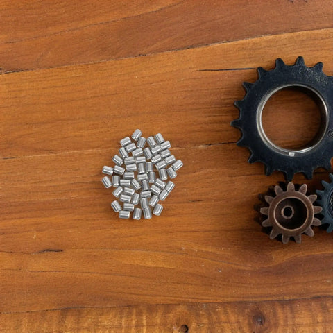 Healeved 50 Pcs Stainless Steel Dowel Pins Offer Solid Shelf Support Pegs For Industrial Machinery Repair With Wear Resistance And Secure Bunk Bed Installation Perfect For DIY Projects And Heavy Duty Jobs arranged on wooden surface with gears.