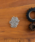 Rock Solid Stainless Steel Dowel Pins For Shelves And Bunks Heavy Duty 50 Pcs displayed on wood surface with gears.