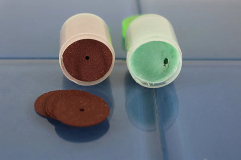 Red and green sanding discs from 100 Piece Rotary Tool Accessory Set For Dremel And Other Rotary Tools With Diamond Burrs Mounted Stones.