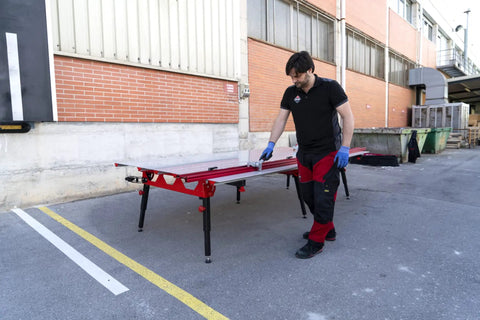 Man using Heavy Duty Adjustable Tile Table For Large Format Ceramic Sheets Extending 43 To 59 Inches outdoors, highlighting its functionality.