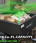 Beefy 400 LB Capacity Tow Behind ATV Trailer Steel Dump Cart With 10 Cubic Feet Bed loaded with firewood