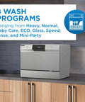 Total Game Changer Compact Countertop Dishwasher In Brushed Stainless Steel with 8 wash programs displayed on the control panel.