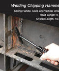 Welding chipping hammer with spring handle used to chip slag from a weld on a rusty metal frame.