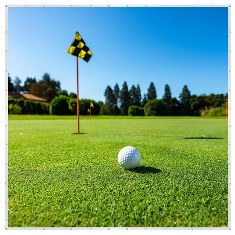 Close-up of a golf ball on green grass with a flag in the distance, suitable for Ultra Clear Golf Simulator Screen For Indoor And Outdoor Practice