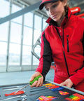 Person in red outfit examines ratcheting screwdriver with one hand switch left right lock magnetic bit holder in toolkit