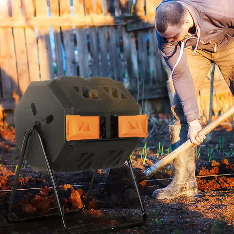 Dual Chamber 43 Gallon Compost Tumbler With Sliding Doors, BPA Free Rotating Batch System For All Season Outdoor Use In Orange, Garden Yard Bin, Easy Turn Design For Faster Rich Soil next to a person working in a garden.