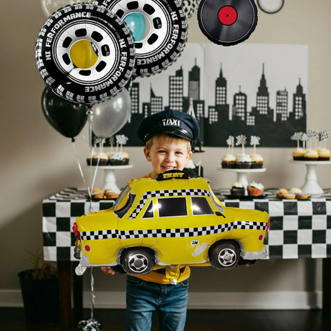 Child holding taxi balloon with Route 66 Retro Party Balloons Kit with Vintage Car Tire Decor and Vinyl Record Foil Balloons.