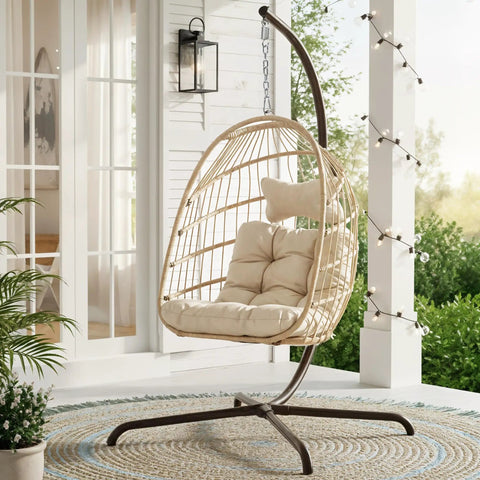 Outdoor Egg Chair With Stand For Patio Backyard Hanging Swing Chair With Foldable Rattan UV Resistant Padded Cushion 350 Lb Capacity Beige Cozy And Chill on a porch