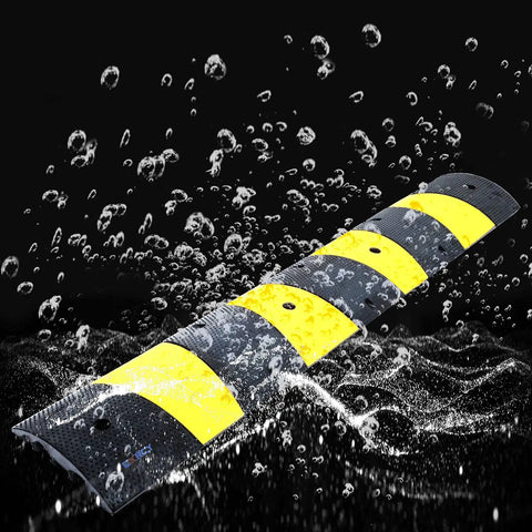 Beefy Heavy Duty 2 Pack 2 Channel Modular Rubber Driveway Speed Bumps And Cable Protector Ramp wet demonstrating weatherproof feature