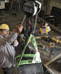 Worker using Half-Ton Hand Chain Hoist with 10 ft lift in industrial setting, 360 degree rotating alloy steel hooks in view.